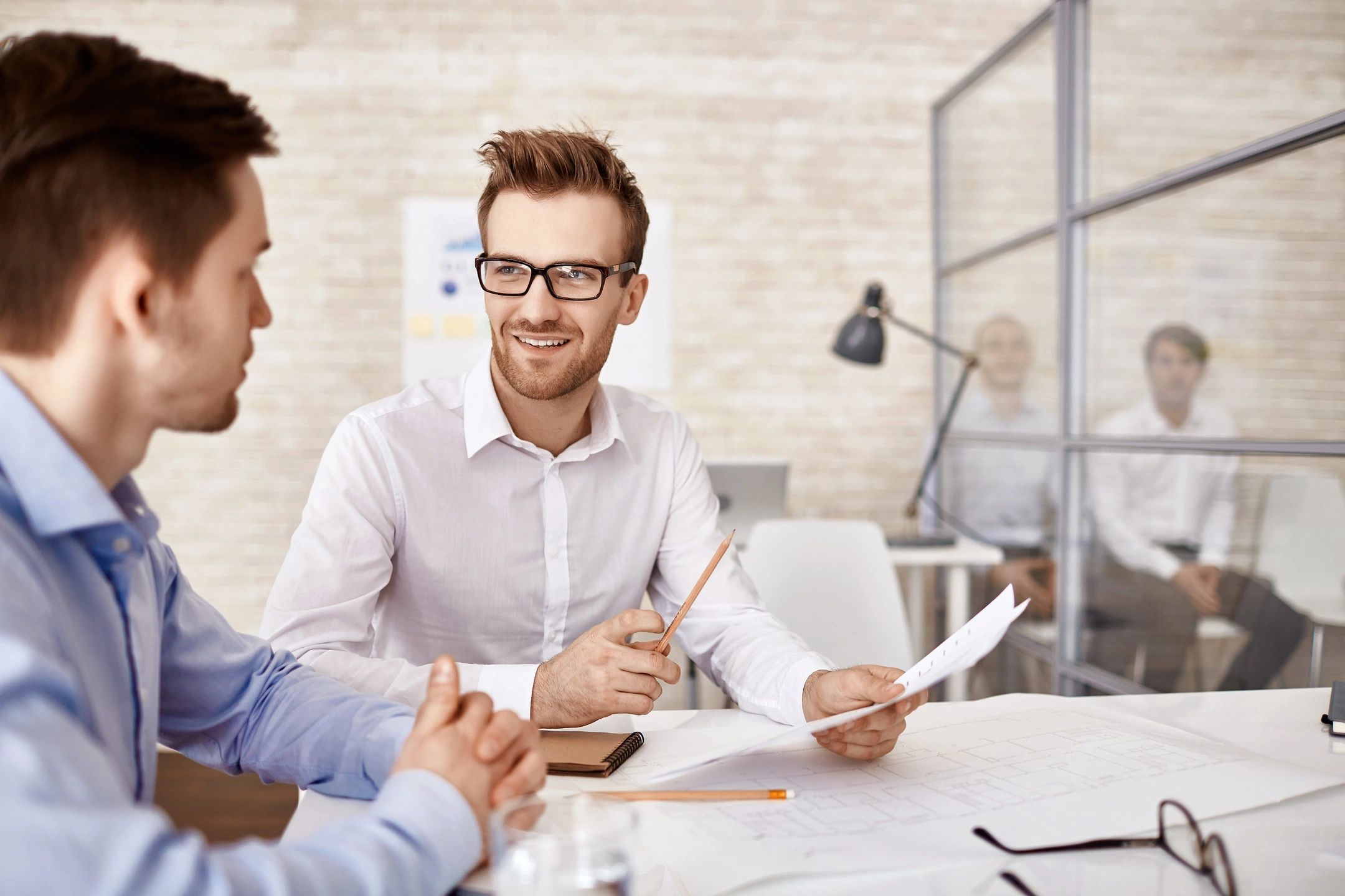 Two professional men in a business discussion at an office